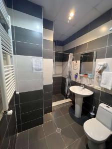 a bathroom with a toilet and a sink at Sanapiro + in Tbilisi City