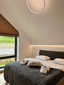 a bedroom with a bed with two towels on it at Altfel Bran Chalet 2 in Bran