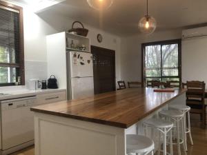 a kitchen with a wooden counter top and a refrigerator at Mataluka at Fish Creek in Fish Creek
