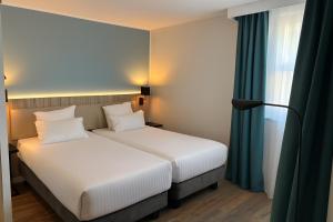 Postel nebo postele na pokoji v ubytování Campanile Reims Centre - Cathedrale