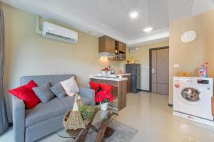a living room with a couch and a kitchen at MIRA Condo 1BR Pool View NBC Nai Harn in Nai Harn Beach