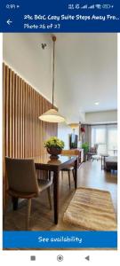 a picture of a living room with a table and chairs at High Floor 2BR Modernized Elegant by A & E CityEscapes at Uptown Parksuites Tower 1 in Manila