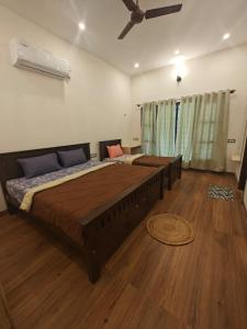 Un dormitorio con una cama grande con ventilador de techo. en NanDha Thotram-The Central Courtyard Heritage HomeStay Yelagiri Hills, en Yelagiri