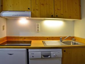 a kitchen with a sink and a counter top at Appartement cosy à Montchavin, ski au pied, 2 pièces, terrasse, parking inclus, proche commerces. - FR-1-329-11 in Bellentre