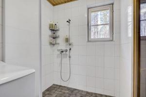 bagno bianco con doccia e finestra di Villa Nova a Pyhätunturi Altre 30 foto