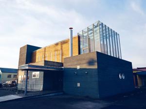 a building with a glass building on top of it at 地元酒屋が手がける一棟貸し宿 -霧ノ音- in Kushiro