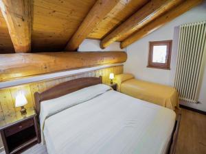 a bedroom with a bed in a wooden cabin at A Cozy Alpine Retreat in Antey-Saint-André
