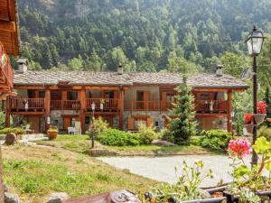 a large wooden house with a mountain in the background at A Cozy Alpine Retreat in Antey-Saint-André +32 photos