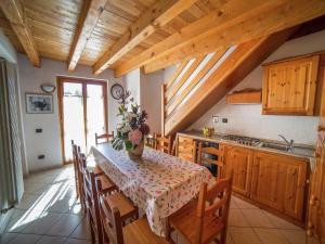 a kitchen with a table with chairs and a sink at A Cozy Alpine Retreat in Antey-Saint-André