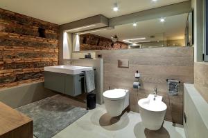 a bathroom with two sinks and a toilet and a mirror at Luxury apartment in the center of Catania in Catania +18 photos