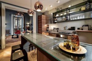 a large kitchen with a counter with a glass appliance at Luxury apartment in the center of Catania in Catania