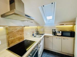 a small kitchen with a sink and a stove at LEO Apartments in Leonberg