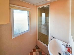a bathroom with a sink and a window at Star Lodge in Rhyl
