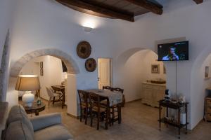 a living room with a couch and a table at Trulli Suite 34 in Alberobello +14 photos
