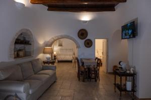 a living room with a couch and a table at Trulli Suite 34 in Alberobello