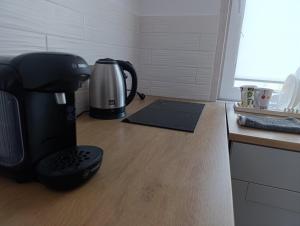 a coffee maker sitting on a counter next to a coffee machine at Дом с террасой in Petrivs'ke