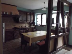 a kitchen with a wooden table and a table and chairs at Gite Alize in Dambach-la-Ville
