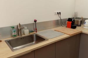 a kitchen counter with a stainless steel sink at Large house terrace entrance Le Touquet in Le Touquet Airport