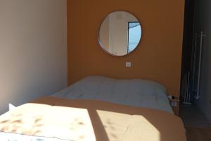 a bedroom with a bed and a round mirror at Large house terrace entrance Le Touquet in Le Touquet Airport