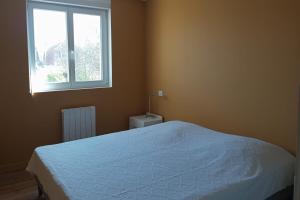 a bedroom with a white bed and a window at Large house terrace entrance Le Touquet in Le Touquet Airport +6 photos