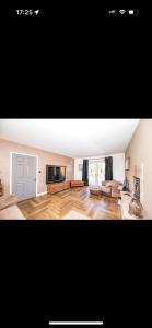 a living room with a couch and a tv at Willow falls in Wortley