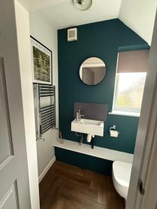 a bathroom with a sink and a toilet at Willow falls in Wortley +17 photos