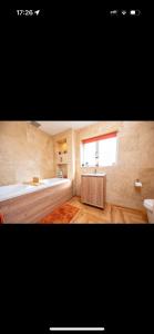 a bathroom with a sink and a bath tub and a window at Willow falls in Wortley