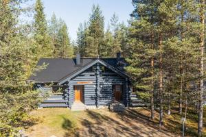 a log cabin in the middle of the woods at Villa Tundra - Valkea Homes in Pyhätunturi