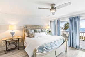 ein Schlafzimmer mit einem Bett und einem Fenster in der Unterkunft Beach Club Villa 32 - Newly Renovated! Direct Oceanfront in Isle of Palms