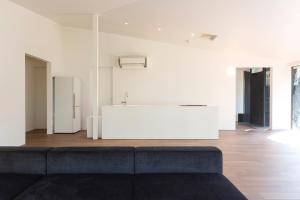 a living room with a couch and a kitchen at Mori no Hanare in Karuizawa