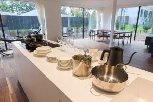 a kitchen counter with pots and pans and plates on it at Mori no Hanare in Karuizawa