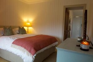 Ένα ή περισσότερα κρεβάτια σε δωμάτιο στο Torran Cottage