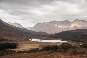 a view of a mountain valley with two lakes at Torran Cottage in Kinlochewe