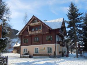 a large wooden house in the snow at Renovated Mountain Retreat Stay in Pruggern
