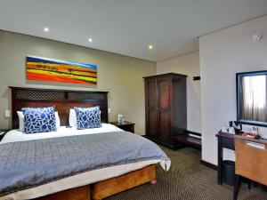 a hotel room with a bed and a television at ANEW Hotel Witbank Emalahleni in eMalahleni