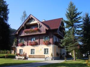 a large house with flowers on the windows at Renovated Mountain Retreat Stay in Pruggern