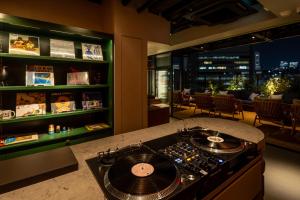 a kitchen with a stove and a counter top at &Here SHINJUKU in Tokyo