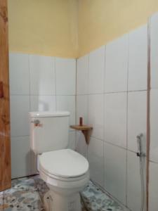 a bathroom with a white toilet in a room at Sunset Backpackers Hostel in Nongkhiaw +6 photos
