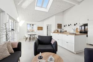 a living room with a couch and a table at Modern Family House Near Købingsmark Beach in Nordborg