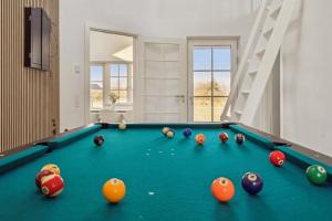 a pool table with balls on it in a room at Modern Family House Near Købingsmark Beach in Nordborg