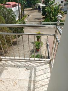 a metal railing on a balcony with potted plants at The Iconic Place in Garki