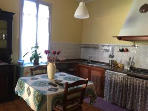 a kitchen with a table with a vase on it at Affitta camere Da Lalla in Dolcedo