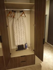 a walk in closet with a tie in it at The Iconic Place in Garki