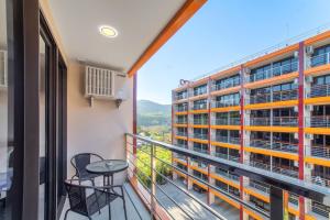 a balcony with a view of a building at SOLA Condo 1BR Tropical View NBC Nai Harn Nai in Rawai Beach