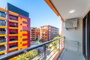 a balcony with a colorful building at SOLA Condo 1BR Tropical View NBC Nai Harn Nai in Rawai Beach