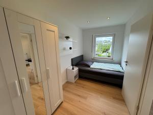 a small bedroom with a bed and a window at Ferienwohnung Sonnenhang nähe WHU in Vallendar