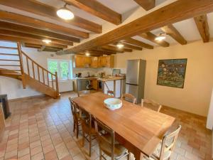 a kitchen and dining room with a wooden table and chairs at Family Home In The Alpes Mancelles in Moulins-le-Carbonnel +22 photos