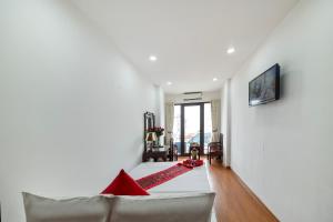 a living room with a couch and a red rug at Hanoi Phoenix Boutique Hotel in Hanoi