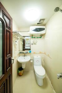 a small bathroom with a toilet and a sink at Hanoi Phoenix Boutique Hotel in Hanoi