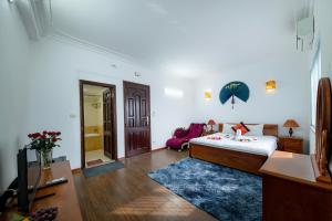 a bedroom with a bed and a living room at Hanoi Phoenix Boutique Hotel in Hanoi